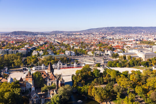 Aerial view of the 1896 eclectic style Vajdahunyad Castle seen in the City Park and the 1900 Heroes&rsquo; Square during a sunny morning, with a cityscape in the background, Budapest, Hungary