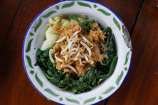 Indonesian salad made with boiled vegetables dressed with spiced grated coconut topping called Urap.