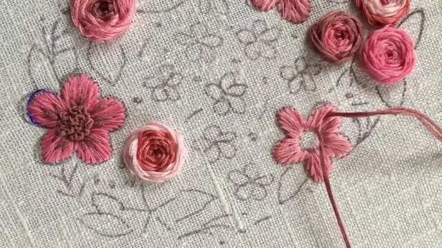 Satin stitch flower embroidery tutorial. Close-up hand stitching colorful floral element on fabric. Step-by-step needlework technique for beginners, DIY craft learning. Part 3