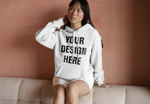 Mockup Of Woman In Customizable Hoodie On Couch