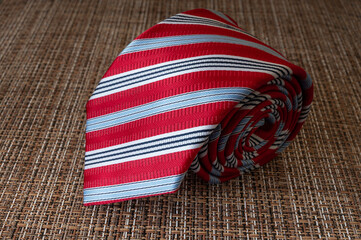 Red Striped Silk Tie on Textured Background &ndash; Elegant Men&rsquo;s Fashion Accessory Close Up