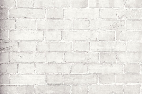 White painted brick wall texture with subtle plaster surface. Minimal neutral architectural background