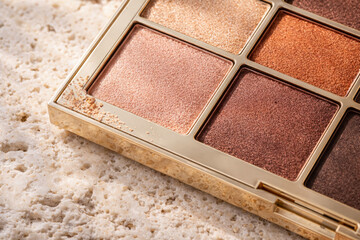 Fototapeta premium Close-up of elegant eyeshadow palette on textured surface