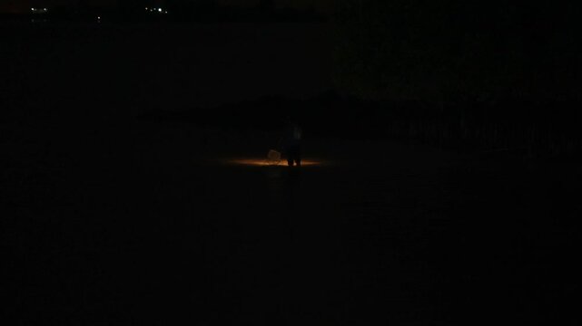 Fisherman Casting Net at Night in Batam, Indonesia with Light Reflections 4K