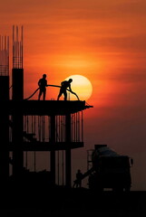 Generated ai silhouette of construction workers pouring concrete with pump truck at sunset sky.