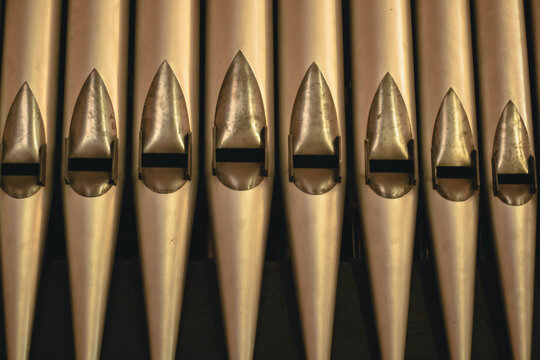 An extra-close shot of old brass organ pipes