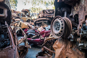 Burnt cars in Ukraine in the Irpin city during the war. Metal scrap