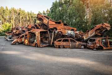 Consequences of the war in Ukraine - heap of destroyed burnt cars in Irpin