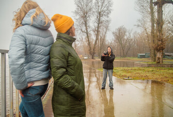 Young Female Friends Enjoying a Professional Photo Shoot in a Misty Autumn Park Near the Lake