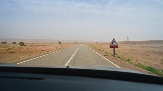Driving through the moroccan desert on a sandstorm day