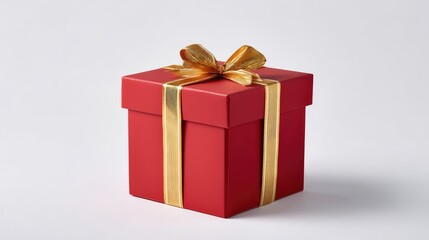 Obraz premium Elegant Red Gift Box with Golden Ribbon on a Simple White Background Ideal for Celebrations, Holidays, Birthdays, or Special Occasions in Stock Photography