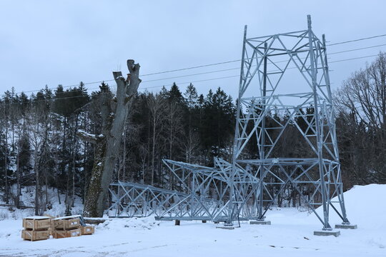 Close Up of how to build a Power Line Pole with blue sky and snow on ground. Perfect illustration to energy related items