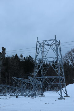 Close Up of how to build a Power Line Pole with blue sky and snow on ground. Perfect illustration to energy related items