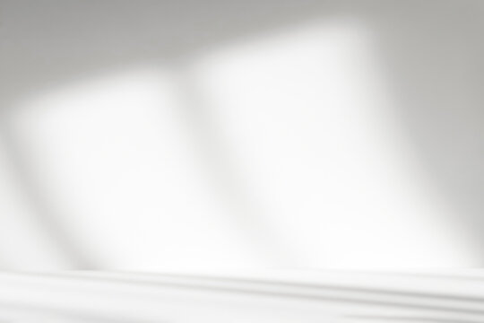 Abstract white studio background with shadows of window. Empty 3d room. Display product with blurred backdrop.