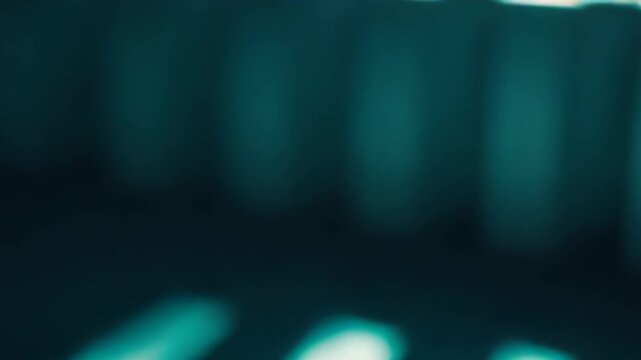 Light stripes cast parallel diagonal shadows across a floor and wall, creating a modern, minimalist geometric pattern in cool teal blue tones with tranquil contrast