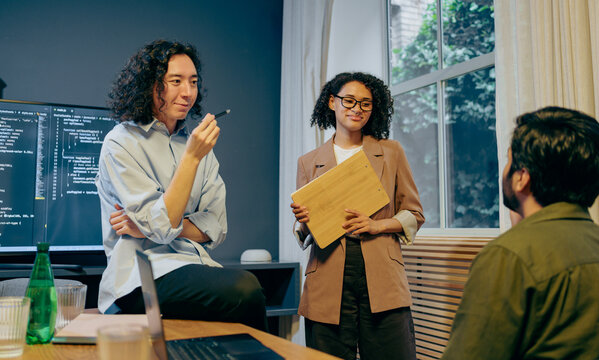team reviewing user data, user experience researcher presenting key findings to diverse team in workspace