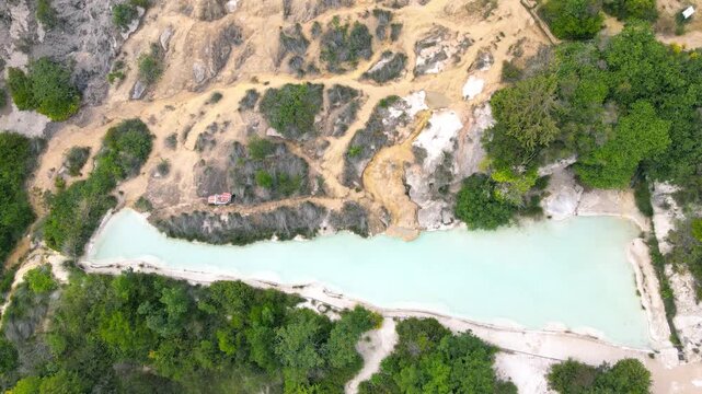 Bagno Vignoni natural pools along the city hill in Tuscany, view in spring season from drone