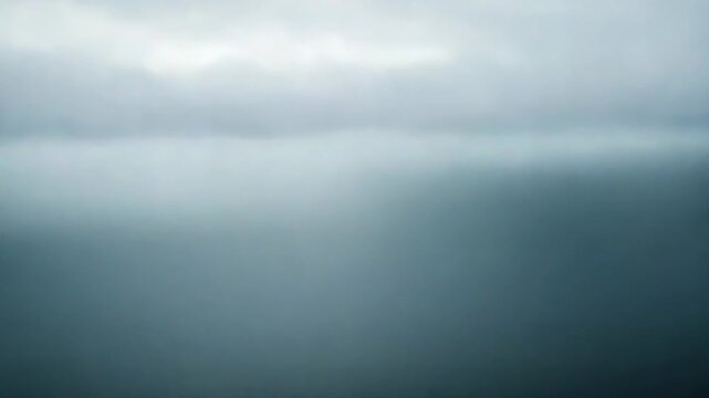 Calm ocean surface mirrors a soft, cloudy sky with misty horizon, evoking serene, ethereal stillness and minimalist coastal tranquility for contemplative scenes