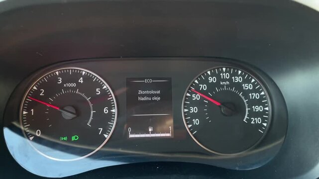 Dashboard with gauges, Speedometer and tachometer display, Instrument panel showing speed and RPM indicators, Vehicle dashboard with illuminated meters and digital information readout