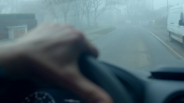Journey through foggy rural pathways, Traveler moves carefully along mistladen village routes, Individual navigates through thick fog that blankets quiet rural village streets at early morning 
