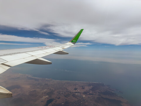 Airplane wing and Pacific Ocean from above - Peru