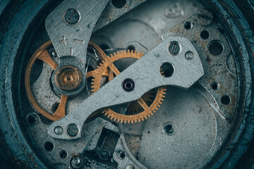Close-up of vintage mechanical gears and cogs, showing worn metal texture, precision engineering, and industrial craftsmanship.