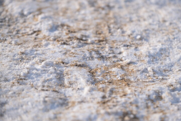 Snow Covered Sidewalk Covered with Sand for Winter Slip Prevention