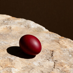 Minimal Orthodox Easter concept with red egg and long shadow