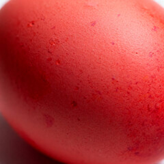 Extreme macro of naturally dyed red Easter eggshell texture