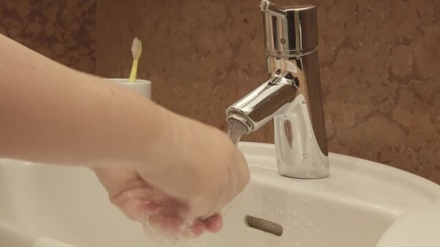 washing hands in sink, morning skincare routine in interior, Self-care and mindfulness, basic hygiene, chrome European plumbing