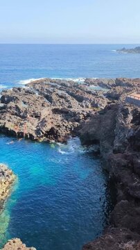 Rocky coastline and turquoise waters with Mount Teide in the background, Costa El Sauzal, Tenerife, Canary Islands, Spain