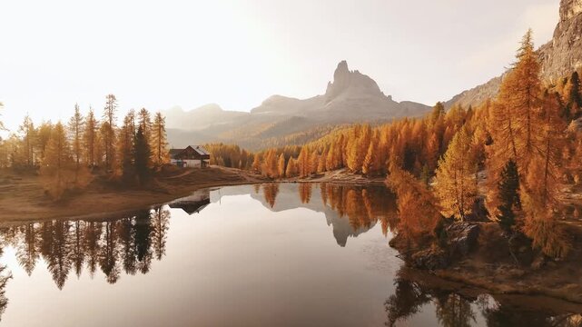 Reflections is in water. Lake Federa near the Croda da Lago mountain at autumn time, majestic landscape, raw nature.