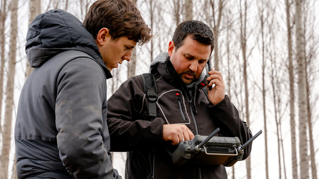 Farmers operating agricultural drone controller