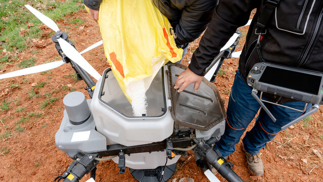 Granular urea pouring into agricultural drone
