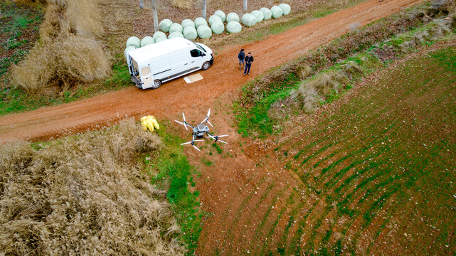 Agricultural drone with solid tank near farm van