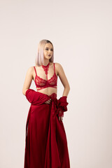 Woman in red lace lingerie and robe posing in a studio