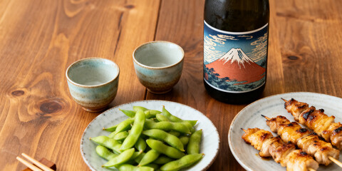 Edamame and yakitori and two cups of sake