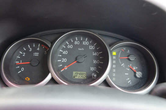 Check engine warning light glowing orange on a dark dashboard