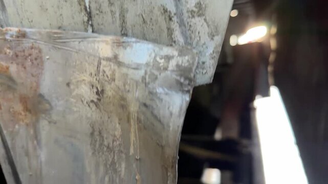A close up low angle shot of a metal diamond plate dock leveler at a warehouse loading bay