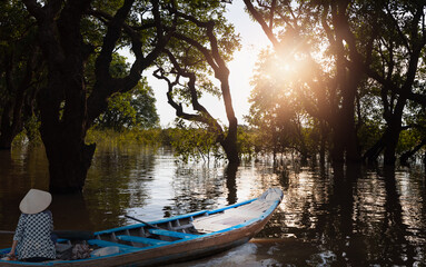Naklejka premium Tonle Sap lake, Siem reap Province, Cambodia. Fisherman in his boat, Floating village of Kompong Phluk, Cambodia.