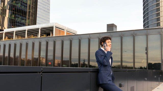 Business professional speaking on phone outdoors