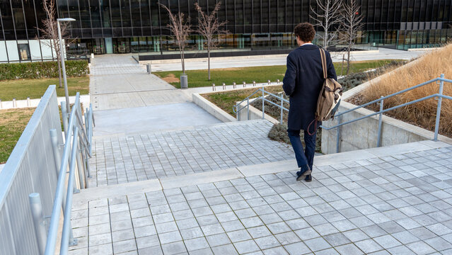 Man walking down steps in an urban setting