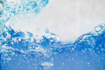 Closeup Transparent blue clear water surface texture with ripples. Abstract​ of​ surface​ blue​ splashes and bubbles​ water waves  reflected​ with​ sunlight​