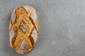 rustic sourdough bread on gray kitchen counter