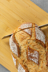 Slicing rustic bread with knife
