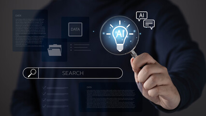 Business professional holding magnifying glass AI light bulb icon with search interface, artificial...