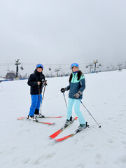 A man and woman on a ski slope in the Polish Tatra Mountains. Polana Szymoszkowa