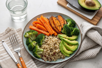 Buckwheat porridge with avocado, carrots, and greens, healthy food, nutrition, diet