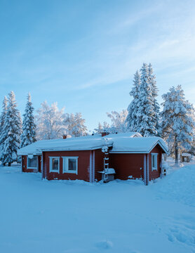 Snow-covered cabin in Akaslompolo Village, serene winter wonderland in Finland