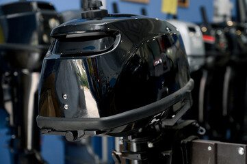 Fototapeta premium Outboard motor in the showroom: close-up of the hull and tiller.